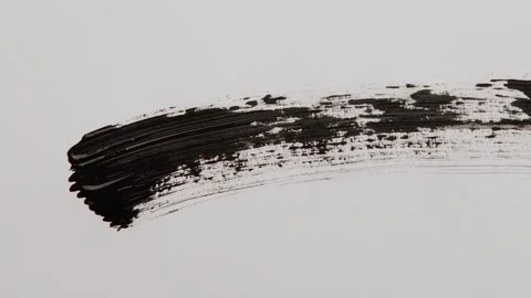 Black mascara stroke. Macro shot a of a black mascara isolated on white backg Stock Footage 258916918