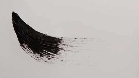 Black mascara stroke. Macro shot a of a black mascara isolated on white backg Stock Footage 258916926