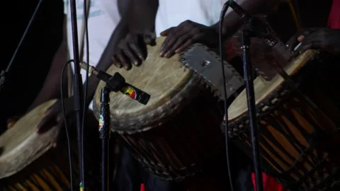 Black men standing playing djembe adorned with drum rings Video stock 208940487