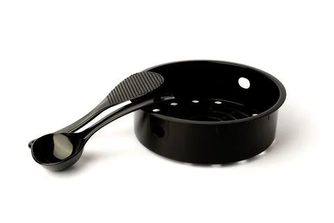 Black mesh multicooker steamer with plastic spoons for cooking isolated on wh Stock Photos
