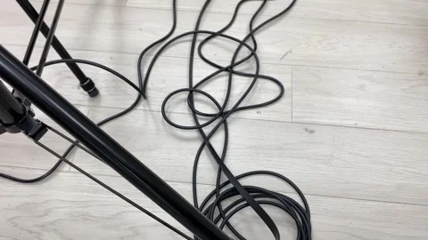 Black messy cable wire on floor inside studio point of view shot. Electricity Video stock 253890710