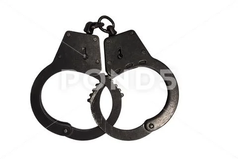 Black metal handcuffs with small scratches on white background Stock Photos