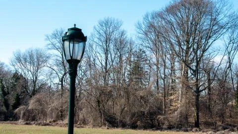 A Black Metal Light Post in a Large Field Stock Photos
