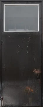 Black metal old door. Texture of peeling black paint Stock Photos