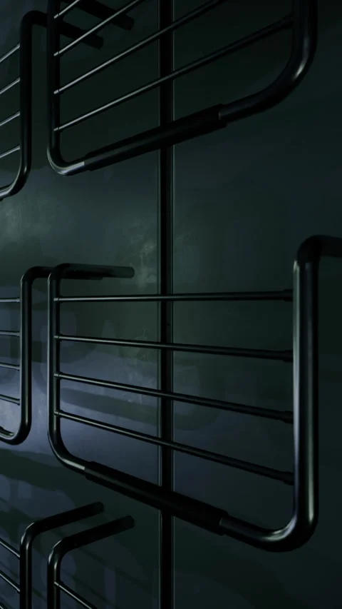 Black metal racks mounted on a dark wall in a storage area at night Stock Footage 330274186