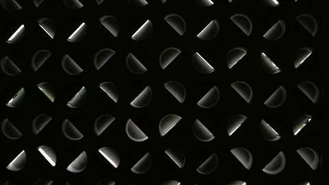 Black metal surface with a repeating pattern of rounded triangular shape Stock Photos
