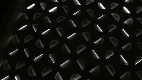 Black metal surface with a repeating pattern of rounded triangular shape 스톡 사진