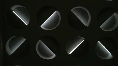 Black metal surface with a repeating pattern of rounded triangular shape Stock Photos