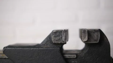 Black metal vise in the workshop, tool workbench close-up. They're closing. Side Stock Footage 146956050