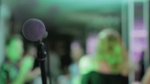 Black mic close-up, back blurred background celebration, bokeh, karaoke Stock Footage 92104483