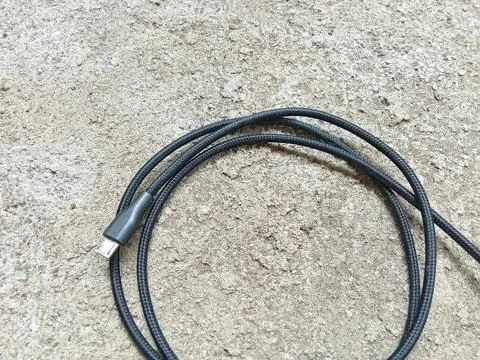 Black micro USB data cable. Stock Photos