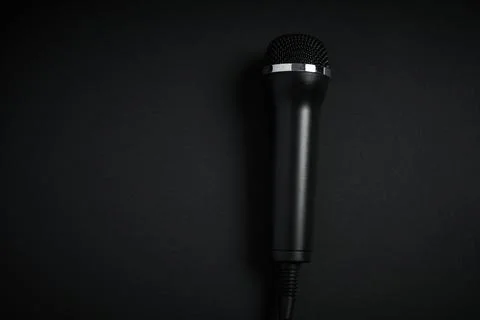 Black microphone on black background Stock Photos