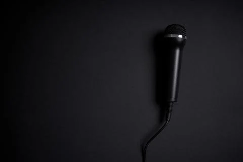 Black microphone on black background Stock Photos