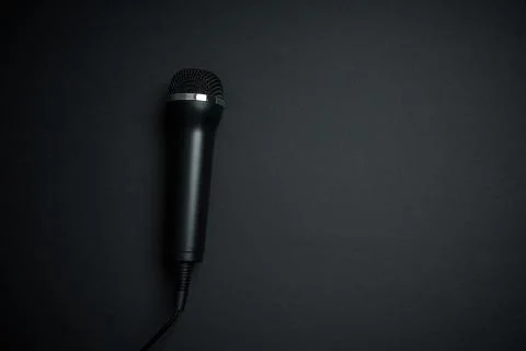 Black microphone on black background Stock Photos
