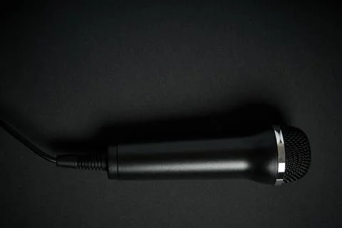 Black microphone on black background Stock Photos