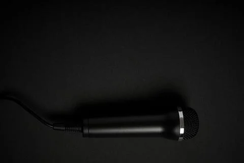 Black microphone on black background Stock Photos