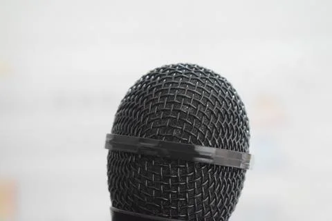 Black microphone close-up with white background Stock Photos