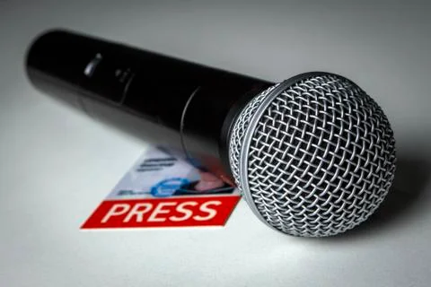 Black microphone with journalistic ID on the table Stock Photos