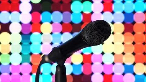 A black microphone on a stand against a background of multicolored lights. Stock Footage 152724535