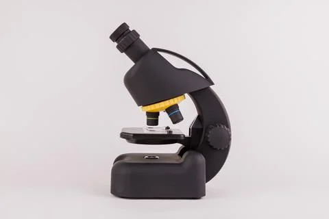 Black microscope on a white background to study the microworld Stock Photos