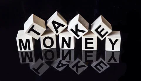 On a black mirrored background with reflection cubes with the text TAKE MONEY Stock Photos