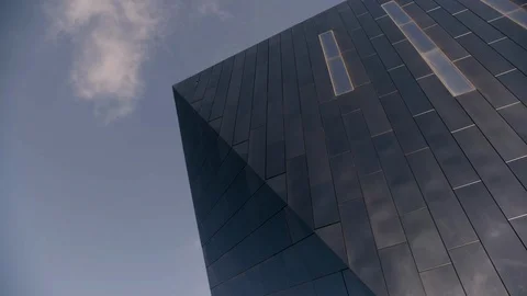 Black Mirrored building detail high tech with wispy cloud in sky Stock Footage 89944875