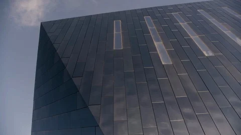 Black Mirrored building detail high tech with wispy cloud in sky wider Stock Footage 89944877