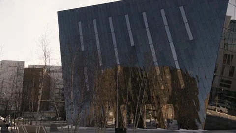 Black Mirrored building high tech pan to right with female pedestrian Stock Footage 89944855