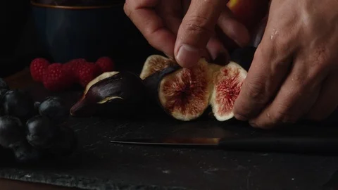 Black Mission Figs - Hands Placing Fig Halves on Table Stock Footage 114014162