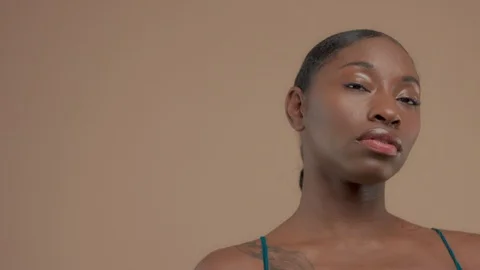 Black mixed race model on beige background with natural neutral makeup Stock Footage 101183090