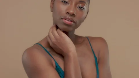 Black mixed race model on beige background with natural neutral makeup Stock Footage 101184251