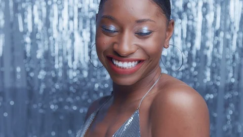 Black mixed race model in glamour glow disco style on silver rain background Stock Footage 99288512