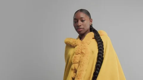 Black mixed race model in studio wear yellow outwear bright outumn look Stock Footage 101190592