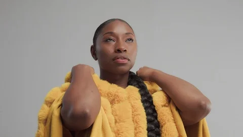 Black mixed race model in studio wear yellow outwear bright outumn look Stock Footage 101193175