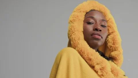 Black mixed race model in studio wear yellow outwear bright outumn look Stock Footage 101197906