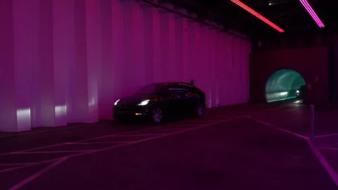 Black Model Y tesla passes Neon Vegas Sign at LVCC Loop Stock Footage 225537143
