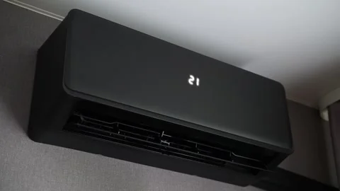 Black modern air conditioning unit mounted on wall. Sleek design with horiz.. Stock Footage 340039866