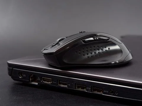 Black modern computer mouse on dark background Stock Photos