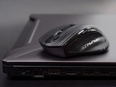 Black modern computer mouse on dark background 스톡 사진