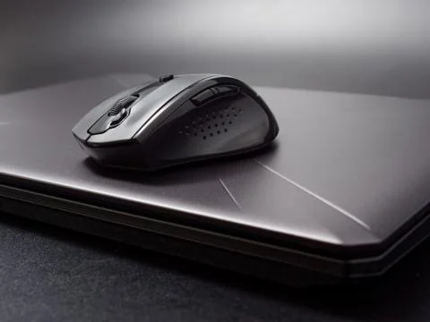 Black modern computer mouse on dark background Foto stock