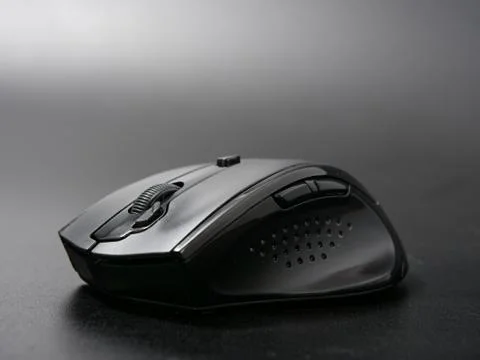 Black modern computer mouse on dark background Stock Photos