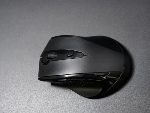 Black modern computer mouse on dark background Stock Photos