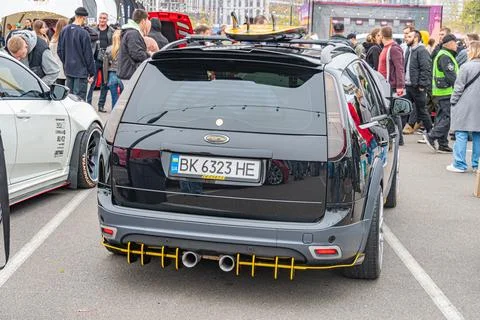 A black, modified German car D-plate with a spoiler, body kit, roll cage, and Stock Photos