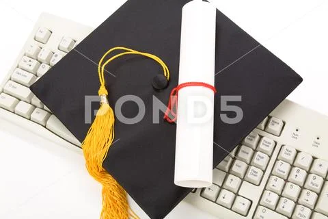 Black Mortarboard and computer keyboard Stock Photos
