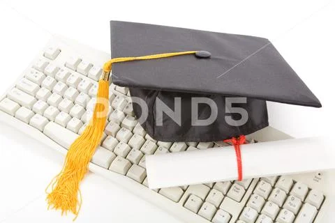 Black Mortarboard and computer keyboard Stock Photos