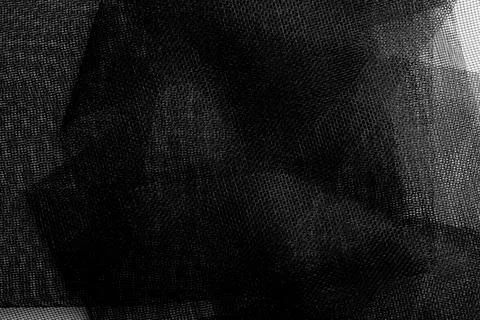 Black mosquito net mesh layers on white table. Abstract geometric texture  Stock Photos