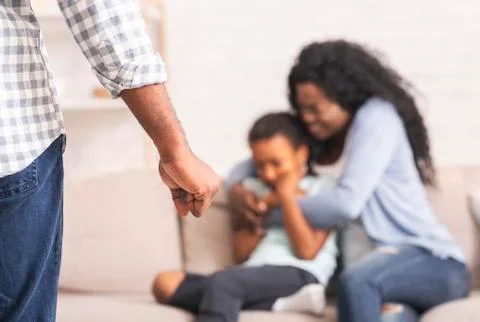 Black mother and daughter suffering from domestic abuse from father Stock Photos