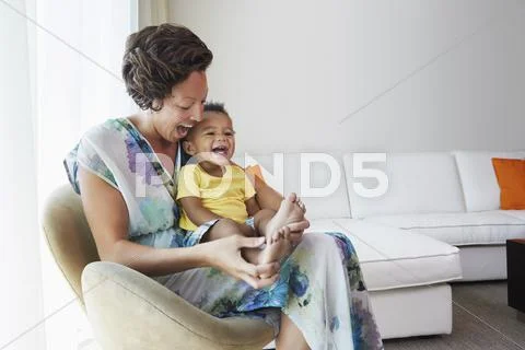 Black Mother And Son Sitting In Living Room