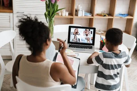 Black mother and son using laptop while working at home Stock Photos