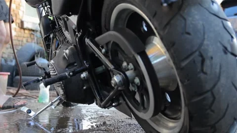 Black motorcycle drenched in water Stock Footage 135447668